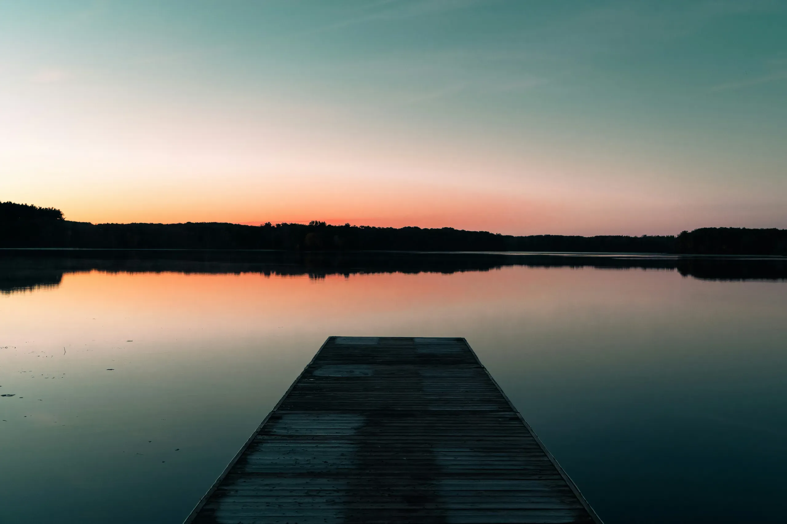 Minnesota. Sunrise over Lake Sagatagan with dock