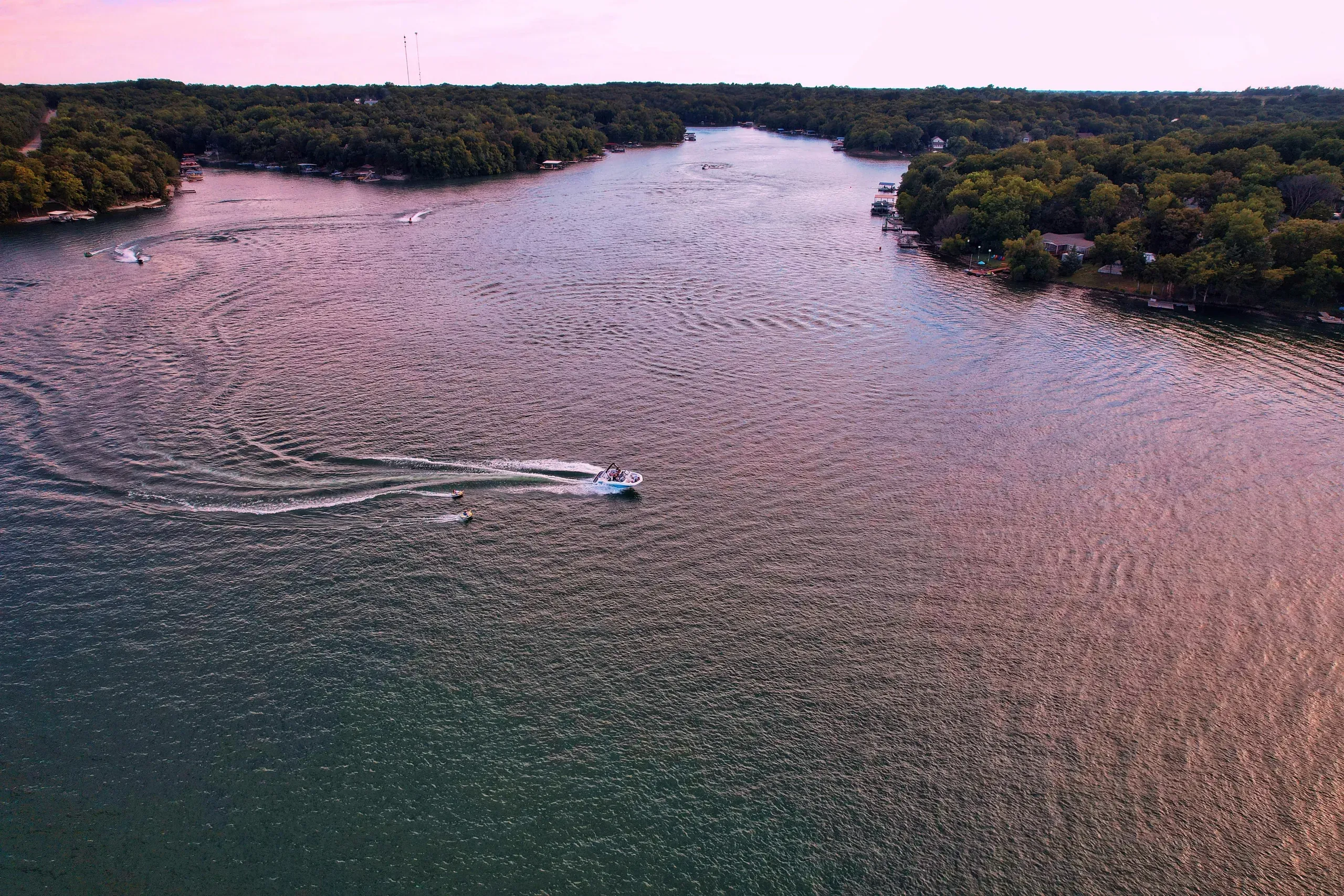 Mound City, Kansas. Motorboat on calm lake at dawn.