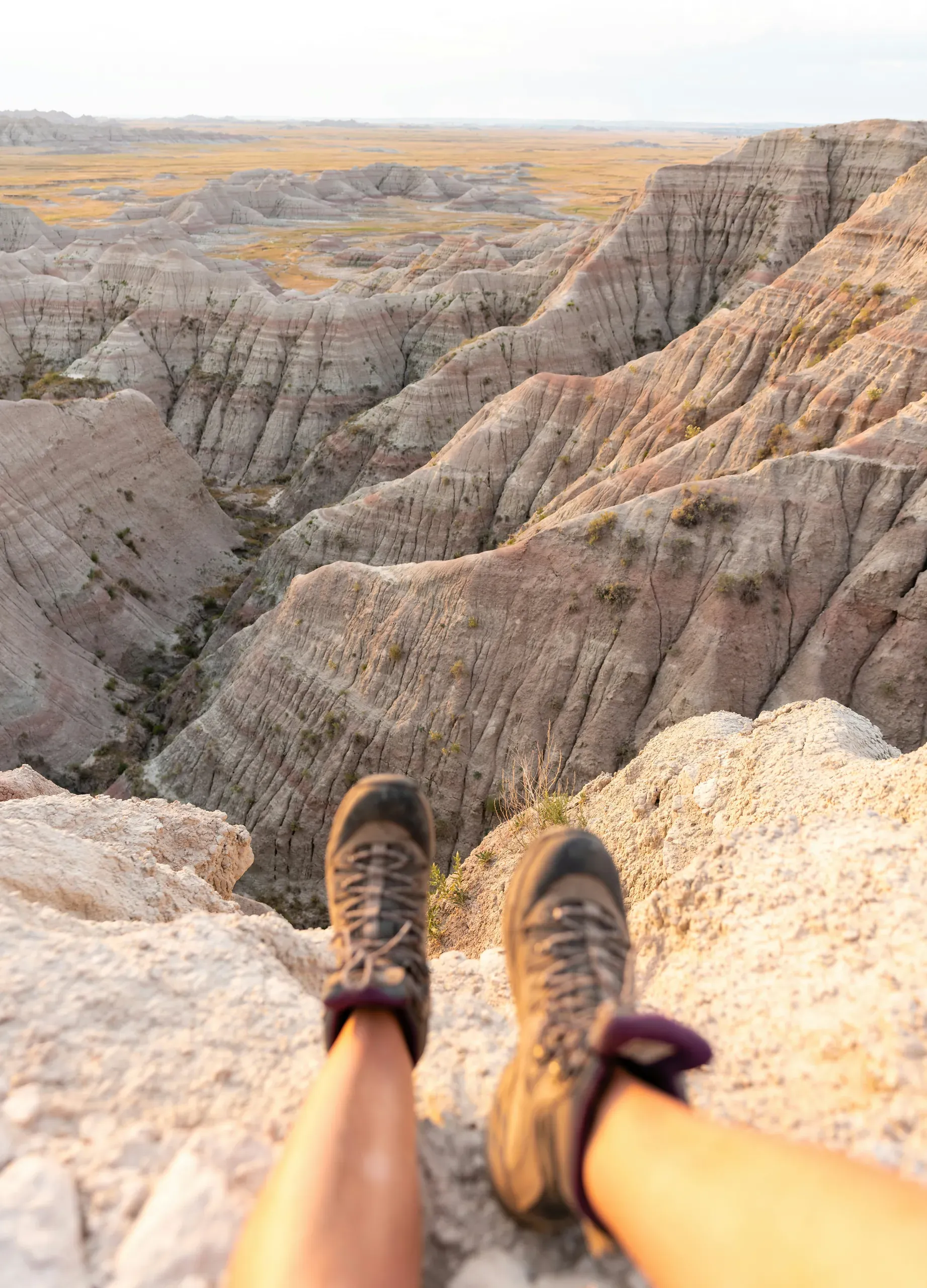 Female hiker catching the early morning light at Big Badlands Overlook, South Dakota