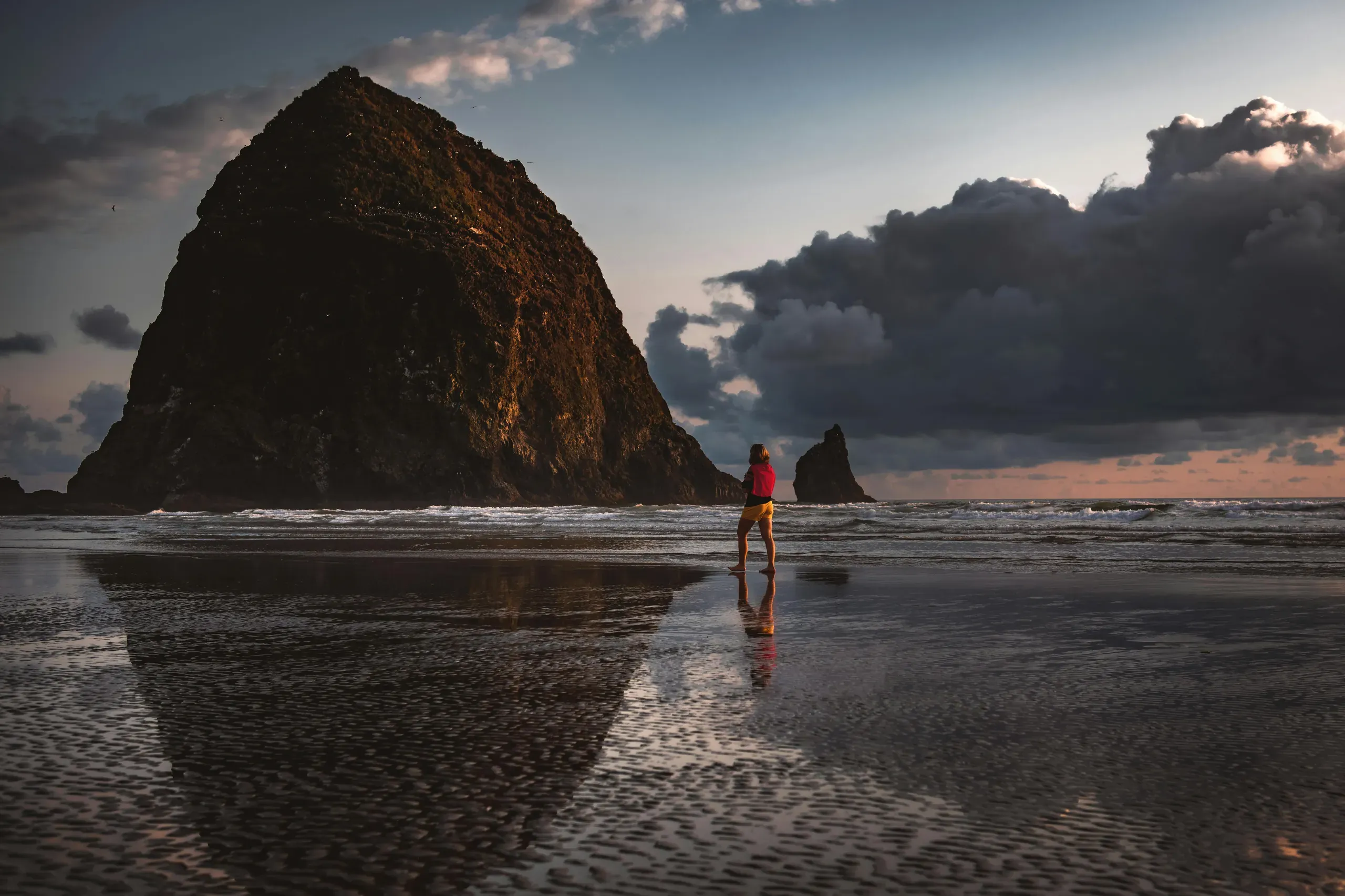 Cannon Beach, Oregon. Person walking on seashore
