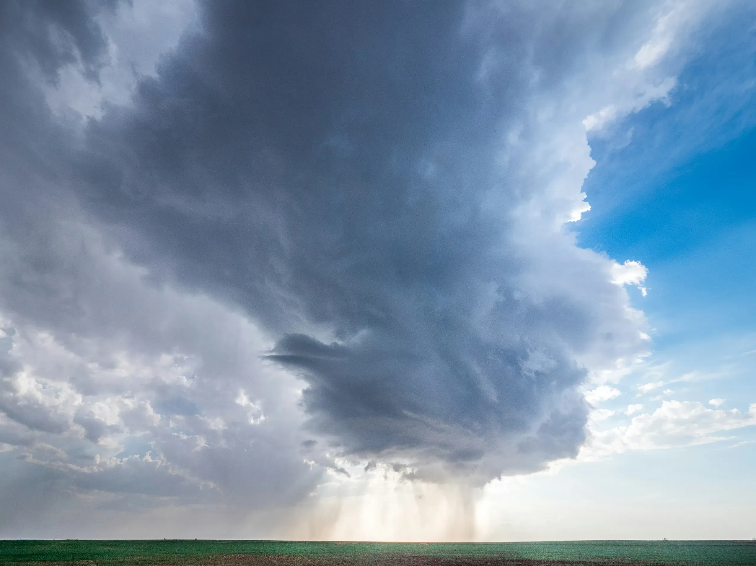 A severe spring storm dropping rain and hail on the Kansas prairie.