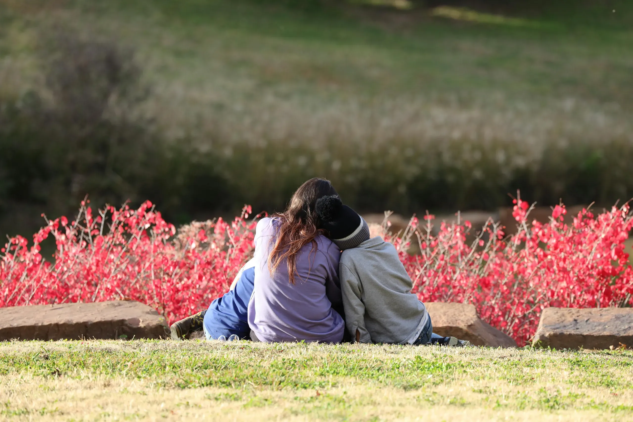 Oklahoma City, Oklahoma. Mother with children sitting on the hillside