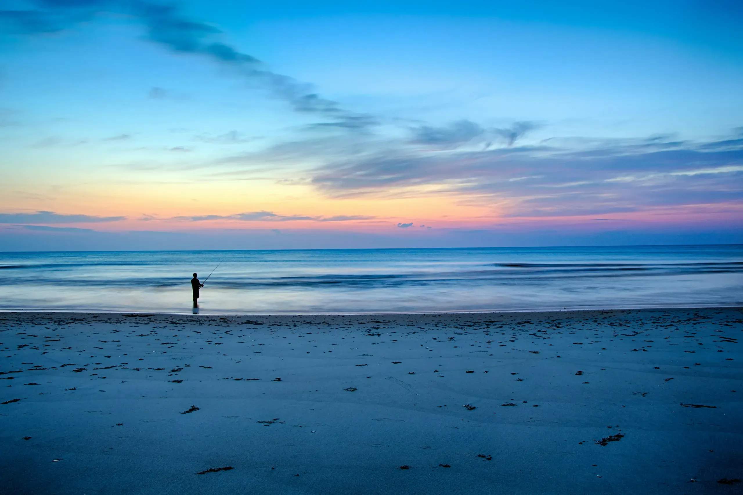 Corolla, North Carolina. Man fishing at the beach
