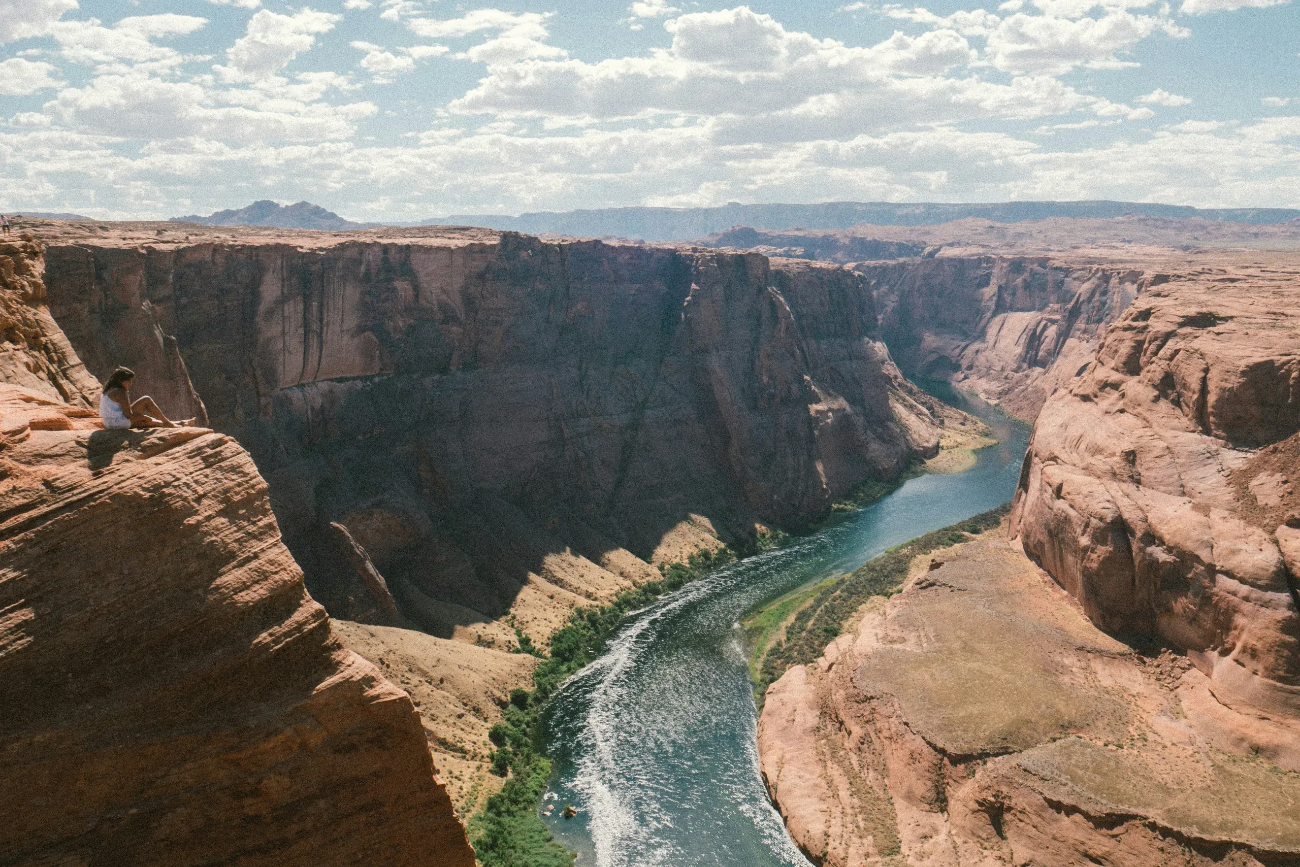Girl sitting on the edge of a cliff near Horseshoe Bend in Arizona