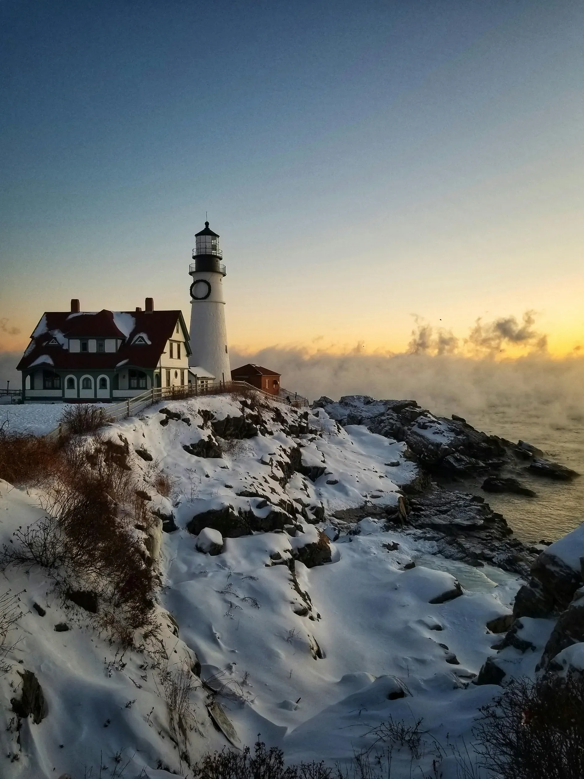The Portland Head Light stands on snow-covered ground during winter in Cape Elizabeth, Maine.