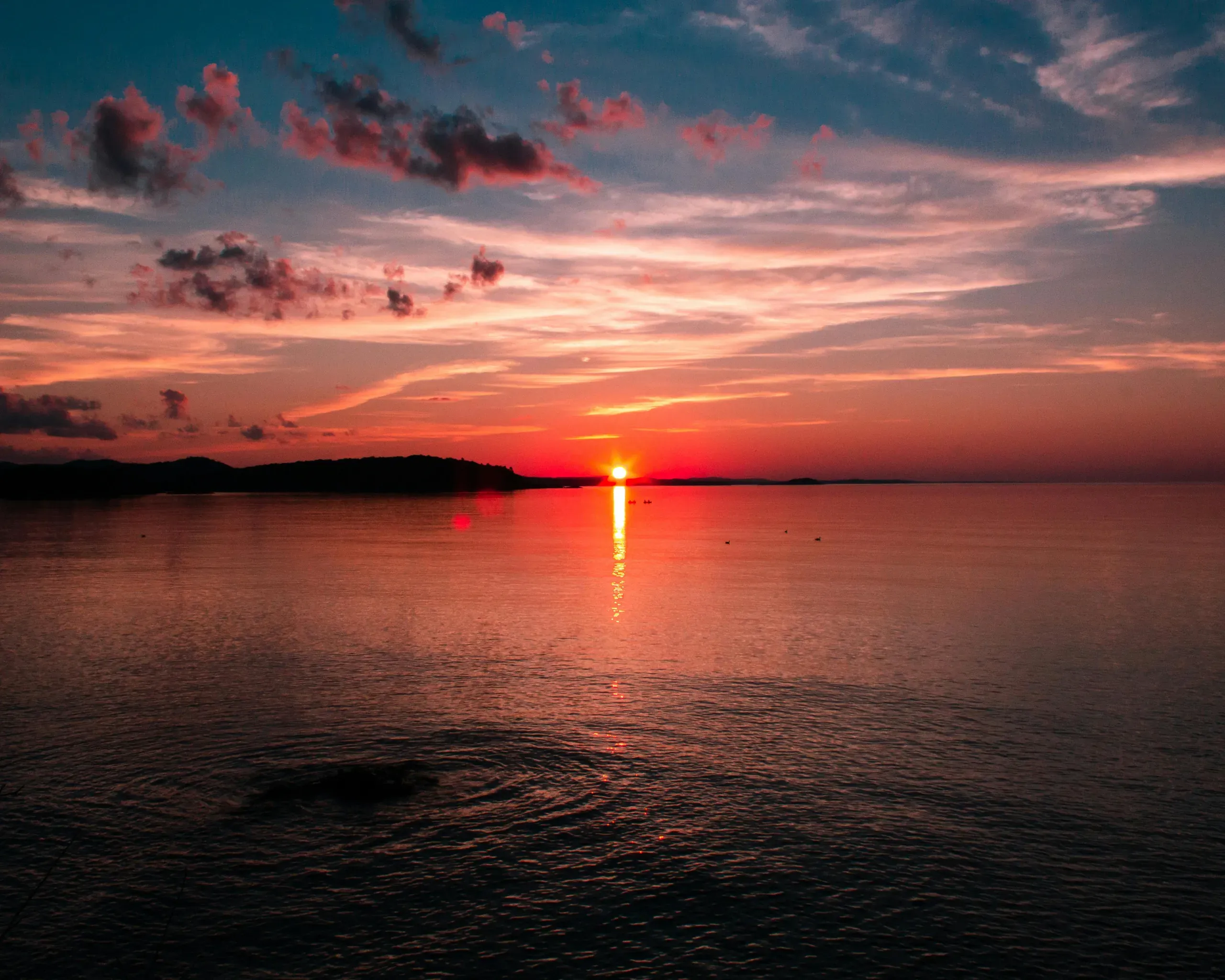 Marquette, Michigan. Body of water near mountain during sunset