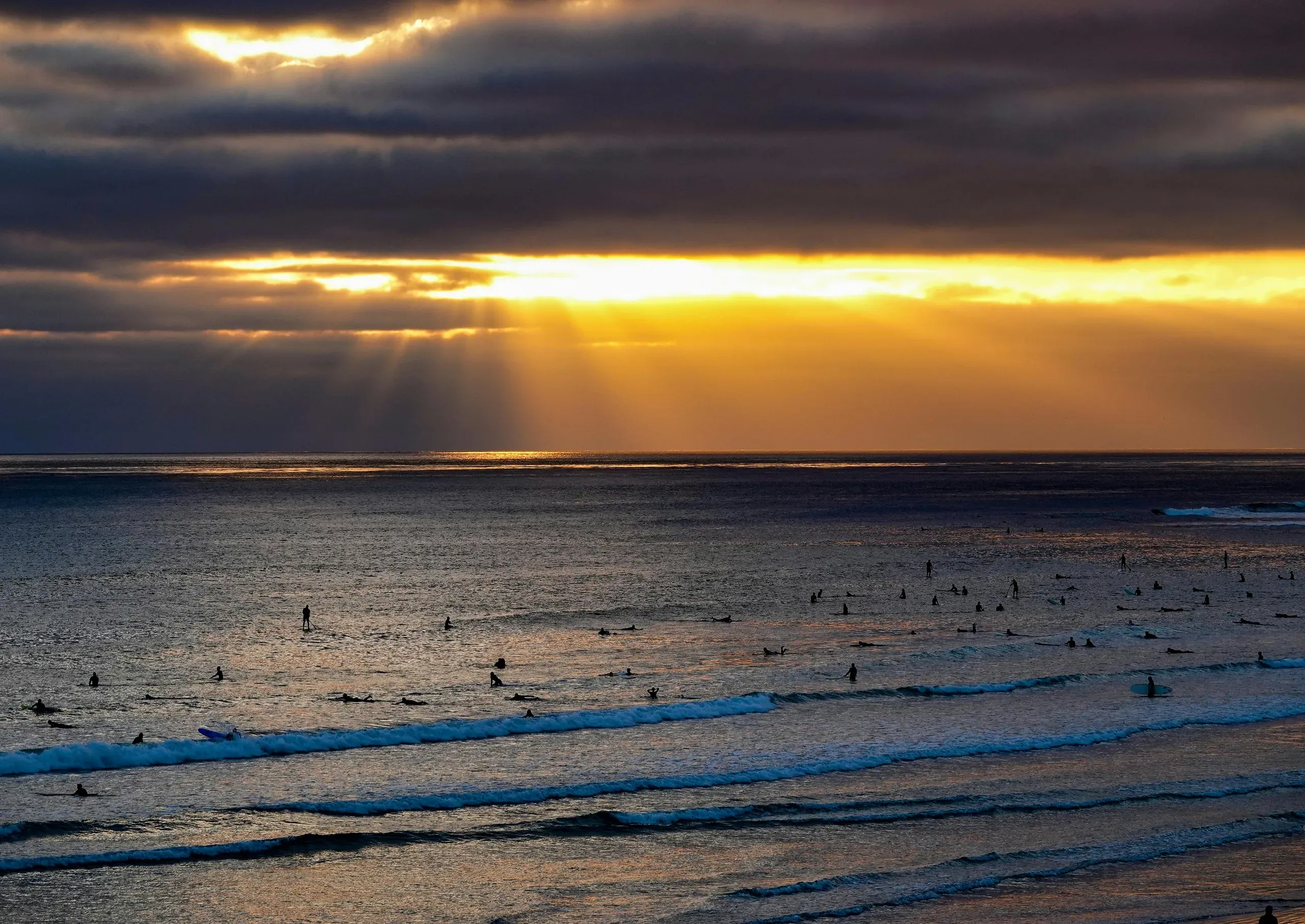 South Padre Island, Texas. Silhouettes of people swimming at the beach