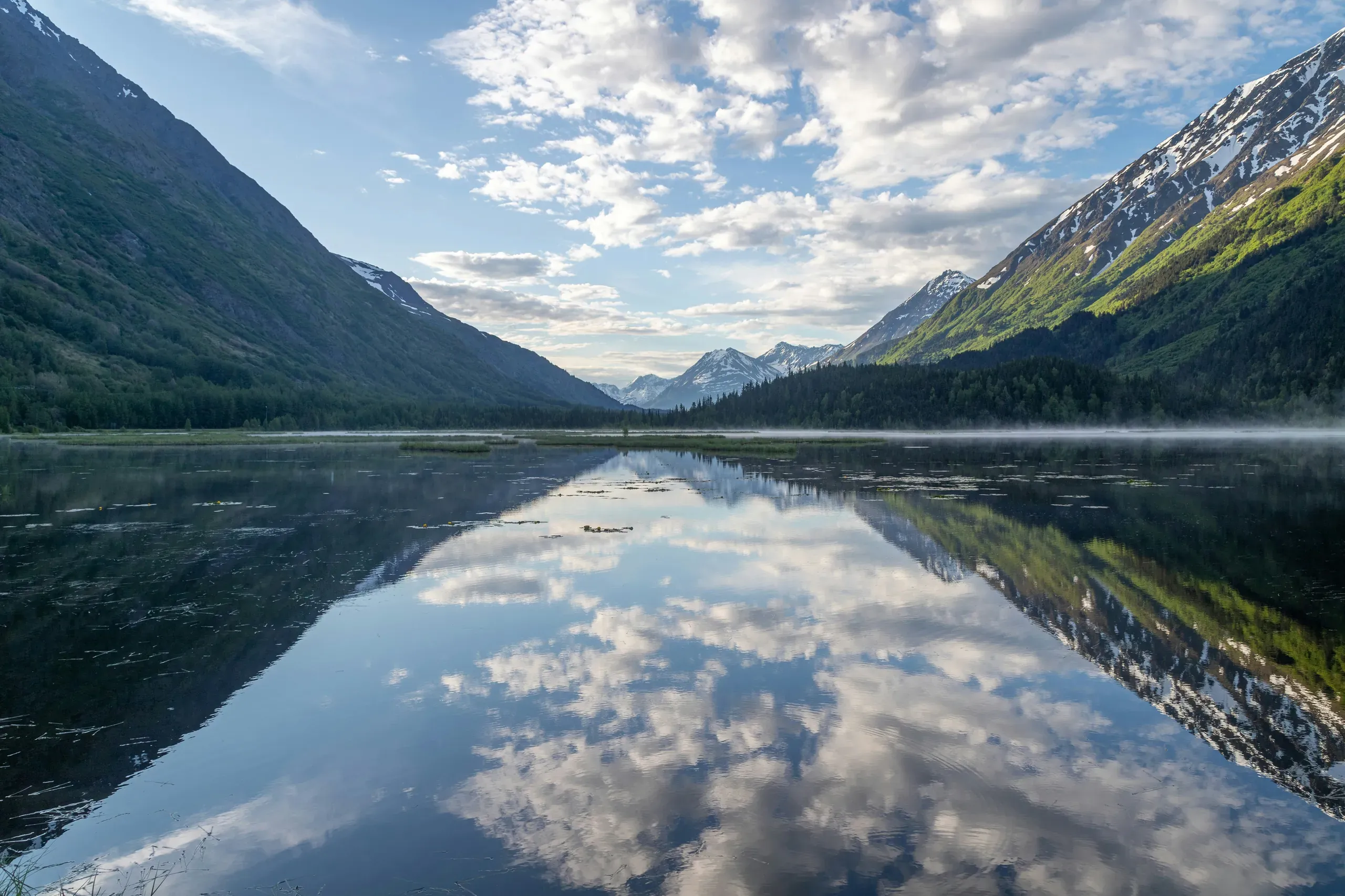 Beautiful still lake reflection in the mountains of the Kenai Peninsula, Alaska.