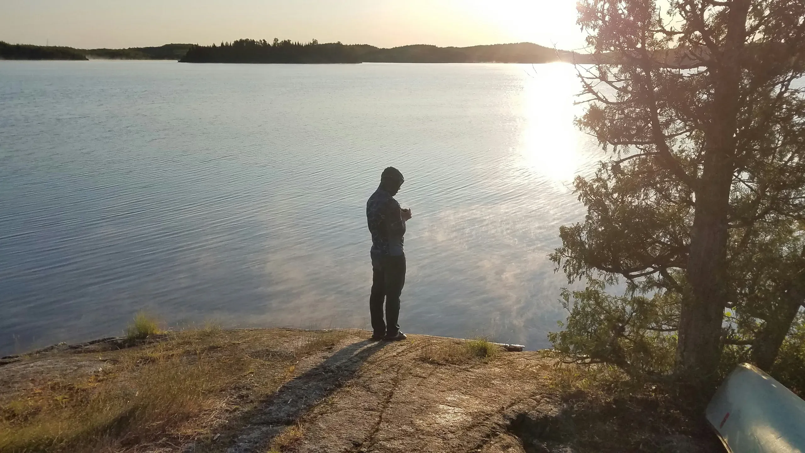 West Cook, Minnesota. Camper by lake with coffee