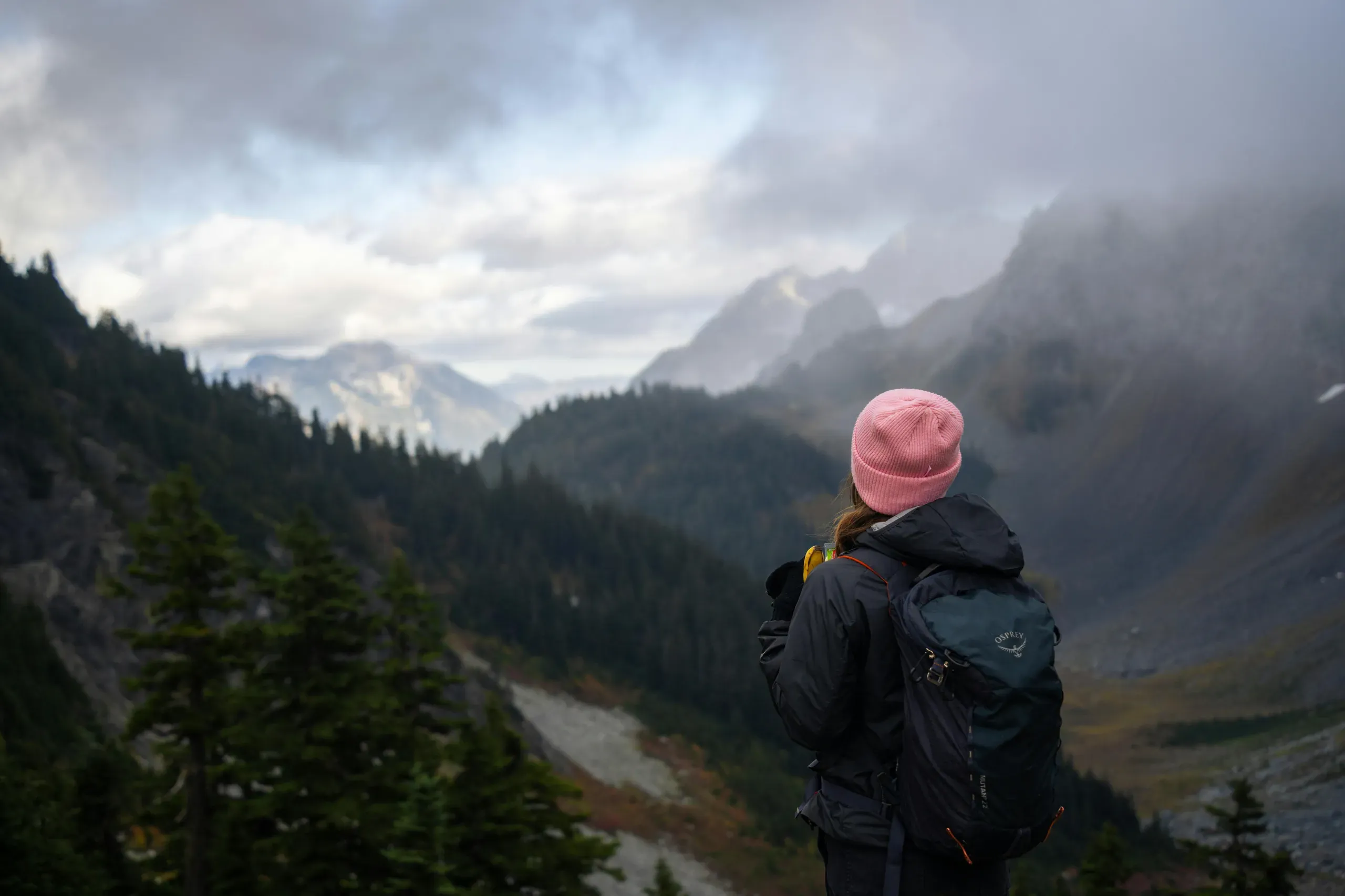 Woman hiking in misty Washington mountains
