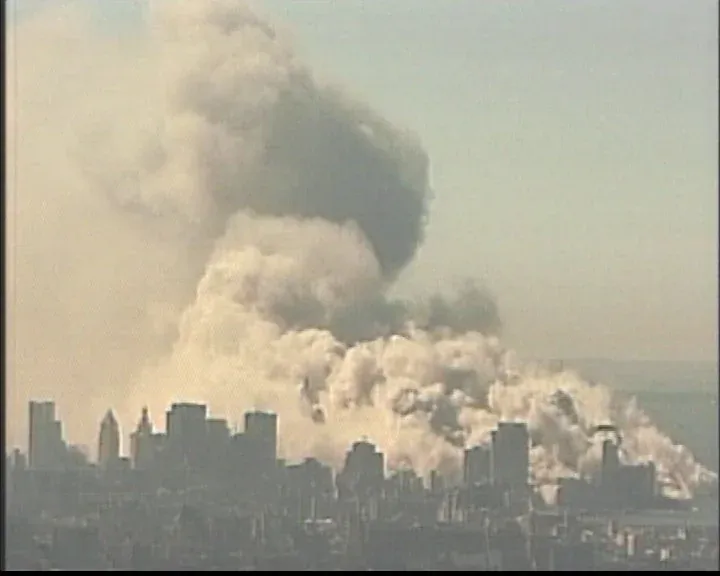 Aerial view of massive mushroom-shaped dust cloud rising high above the Manhattan skyline during WTC collapse
