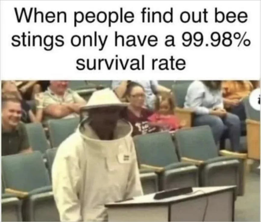 Meme captioned When people find out bee stings only have a 99.98% survival rate showing person at a public meeting wearing a full beekeeper suit