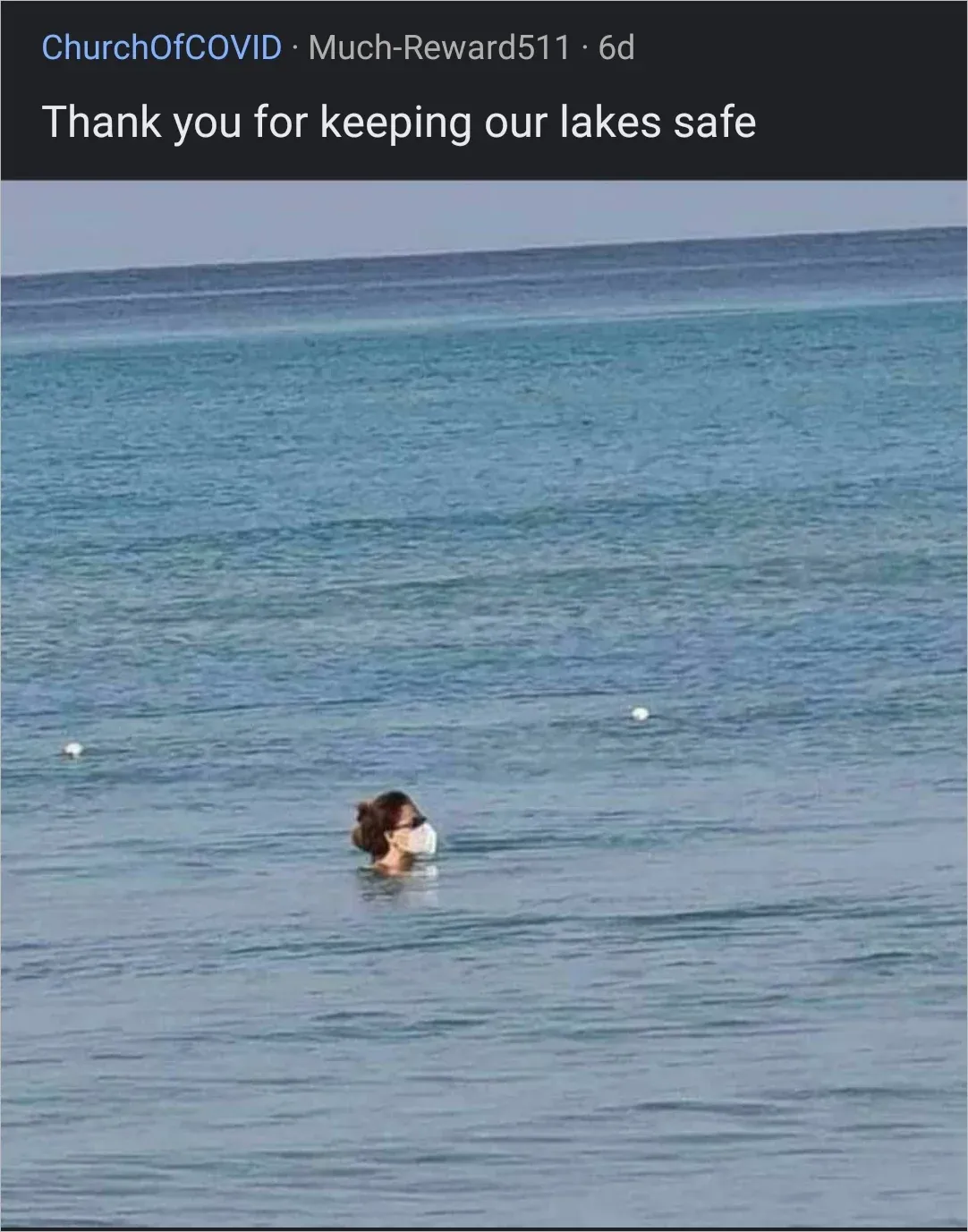 r/ChurchOfCOVID post captioned Thank you for keeping our lakes safe showing a person swimming in the ocean with only their head above water, wearing a white face mask while swimming