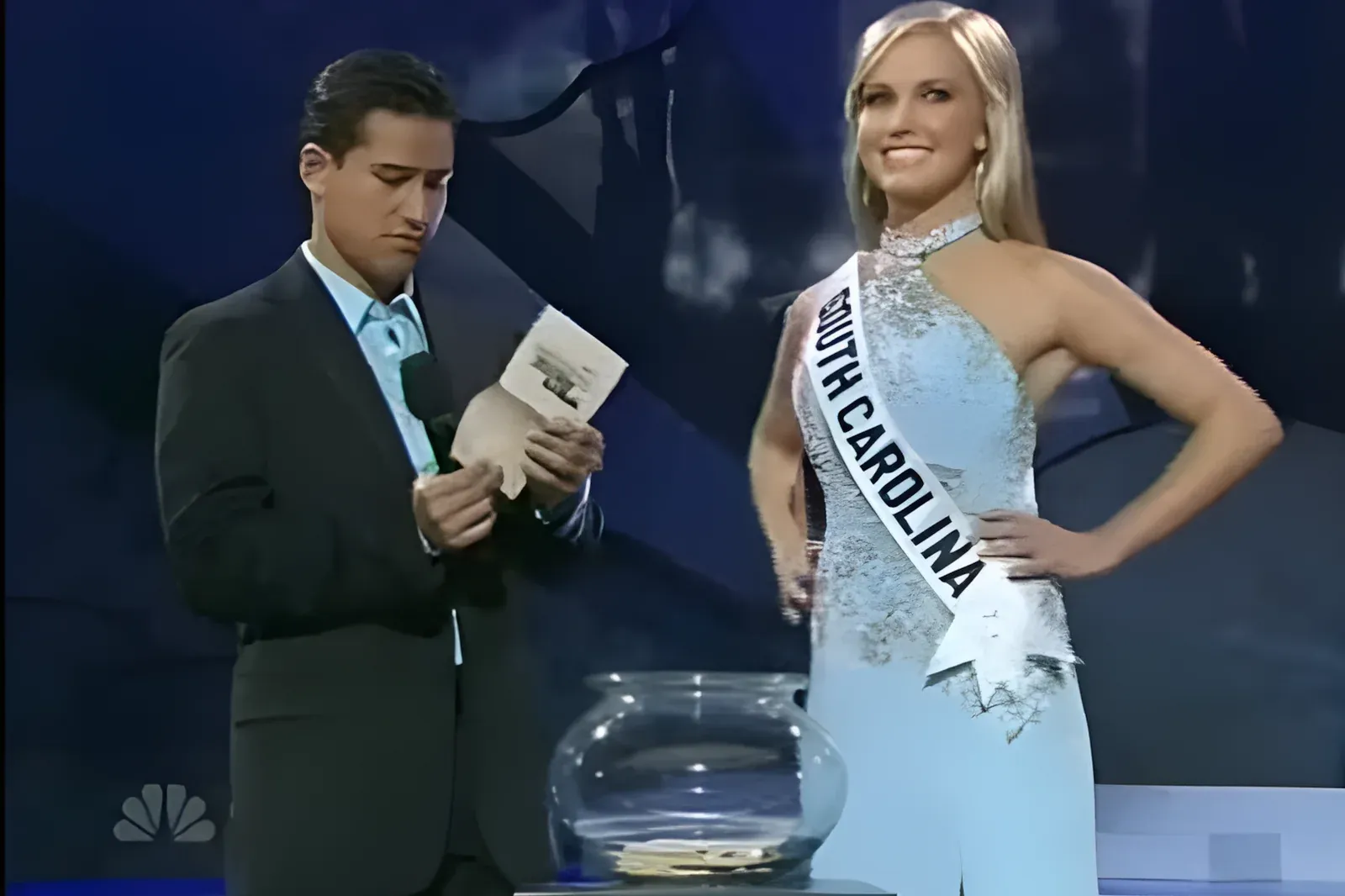 Miss Teen South Carolina wearing her sash and a pale blue gown on stage at Miss Teen USA 2007, with the host holding a question card beside her