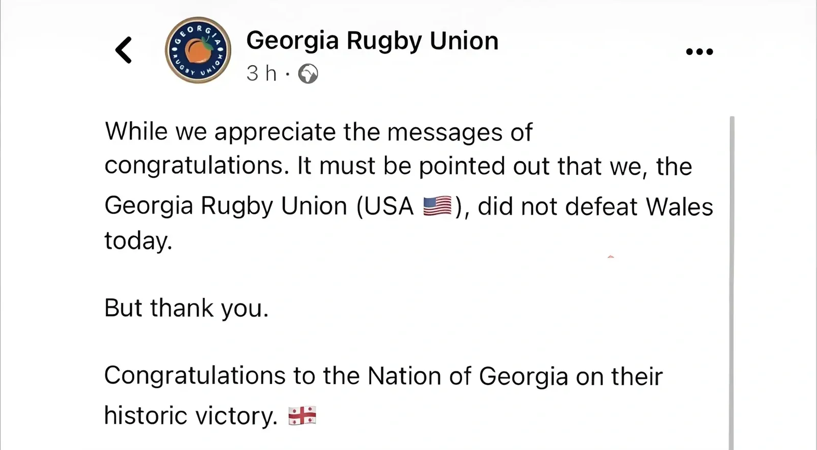 Facebook/social media post. Georgia Rugby Union (peach logo, 3h, public): "While we appreciate the messages of congratulations. It must be pointed out that we, the Georgia Rugby Union (USA), did not defeat Wales today. But thank you. Congratulations to the Nation of Georgia on their historic victory." with US flag and Georgian flag emojis