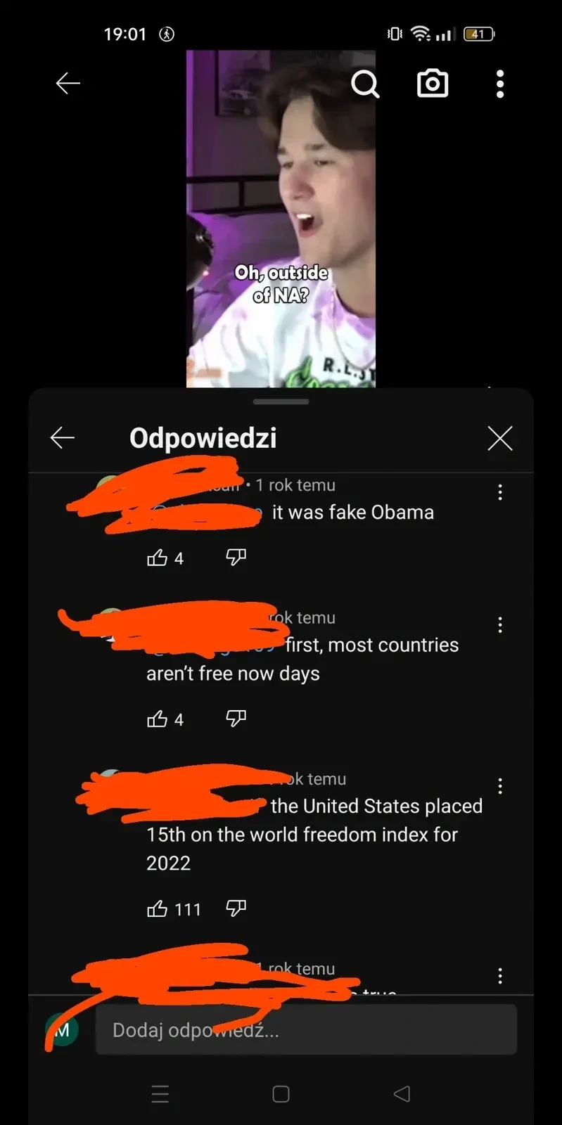 YouTube screenshot with Polish-language interface ("Odpowiedzi"). Video thumbnail showing young man in dark room. Comment thread: first comment: "The US freedom index is 15th in the world for 2022." Reply (astronaut avatar): "Oh, outside of NA?"