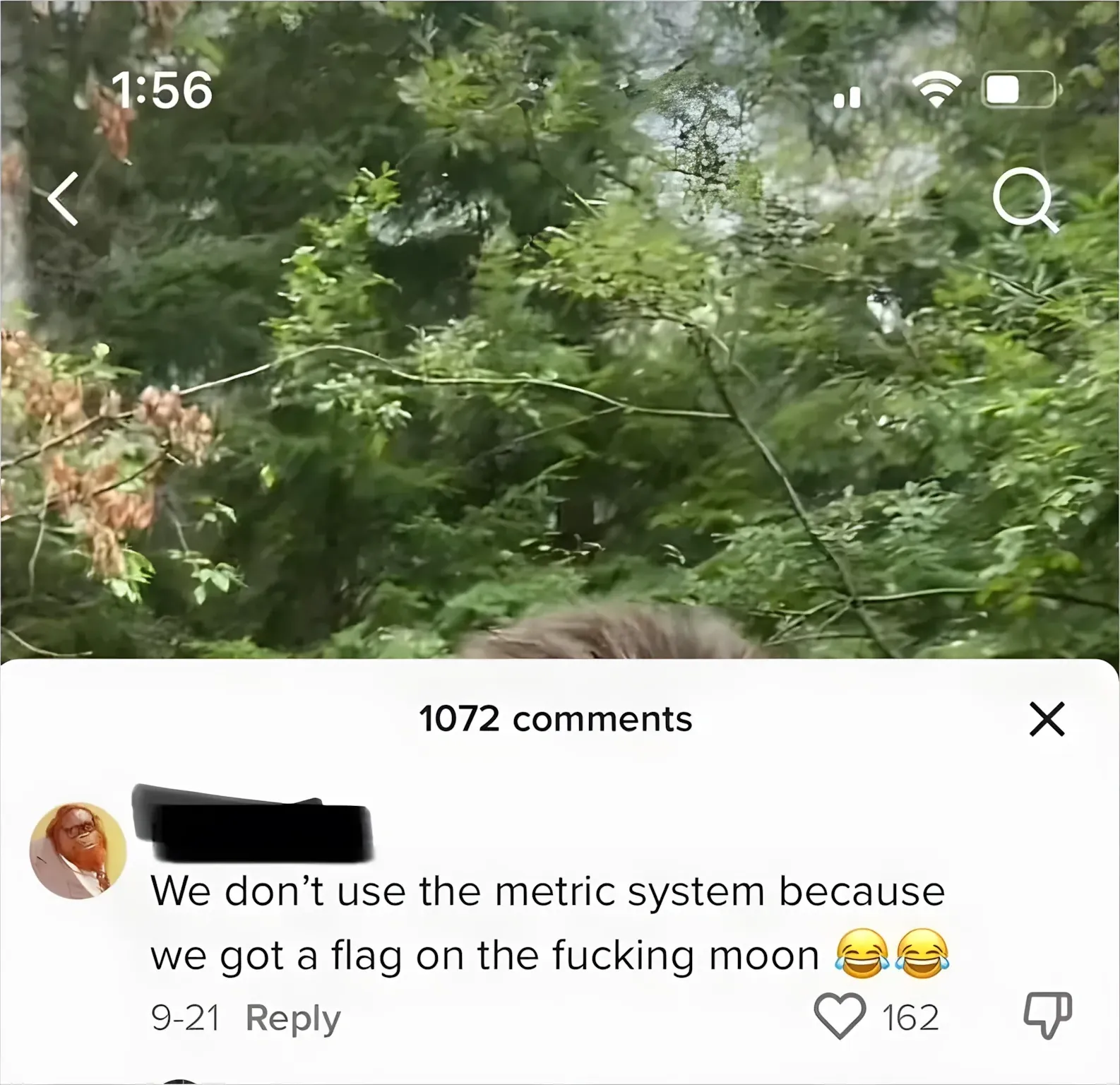 TikTok/Instagram screenshot. Video showing dense green foliage/trees. Comment (username redacted, 9-21): "We don't use the metric system because we got a flag on the fucking moon" with two laughing-crying emojis