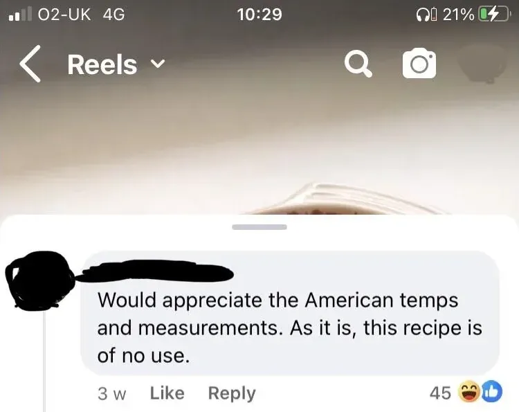 Instagram Reels screenshot (O2-UK 4G, 10:29). Video thumbnail showing blurred pages of a book/recipe. Comment below (username redacted, 3w, laughing and thumbs-up reactions): "Would appreciate the American temps and measurements. As it is, this recipe is of no use."
