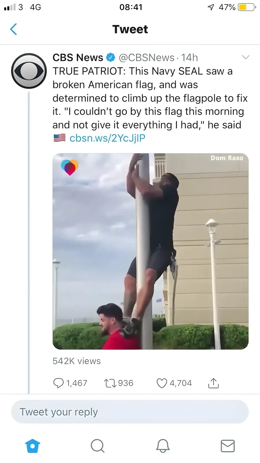 Twitter/X post by CBS News (@CBSNews, verified, 14h). Tweet: "TRUE PATRIOT: This Navy SEAL saw a broken American flag, and was determined to climb up the flagpole to fix it. 'I couldn't go by this flag this morning and not give it everything I had,' he said" with US flag emoji. Video/photo showing man (Dom Raso) climbing a flagpole with another man helping below.