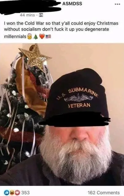 Facebook post screenshot (ASMDSS page, 44 mins). Photo of an older man with a white beard wearing a "U.S. SUBMARINE VETERAN" hat (eyes redacted), standing in front of a Christmas tree. Text: "I won the Cold War so that y'all could enjoy Christmas without socialism don't fuck it up you degenerate millennials" with skull, Christmas tree, heart and American flag emojis.