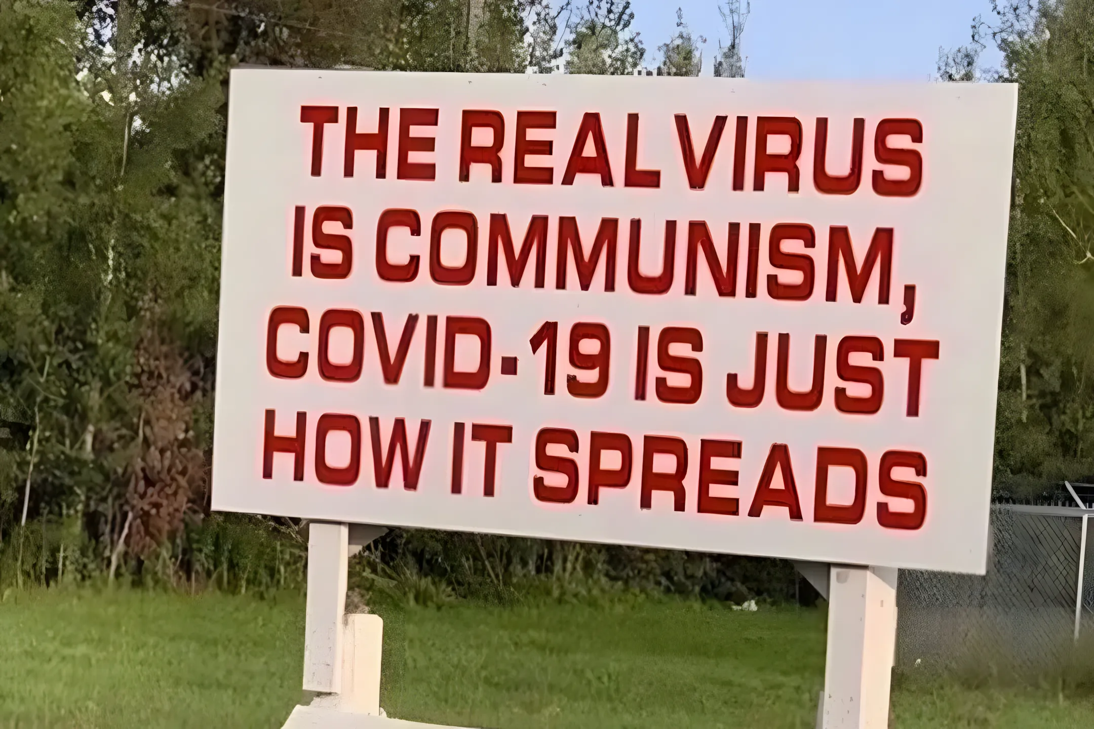 Roadside sign reading 'The real virus is communism, COVID-19 is just how it spreads'