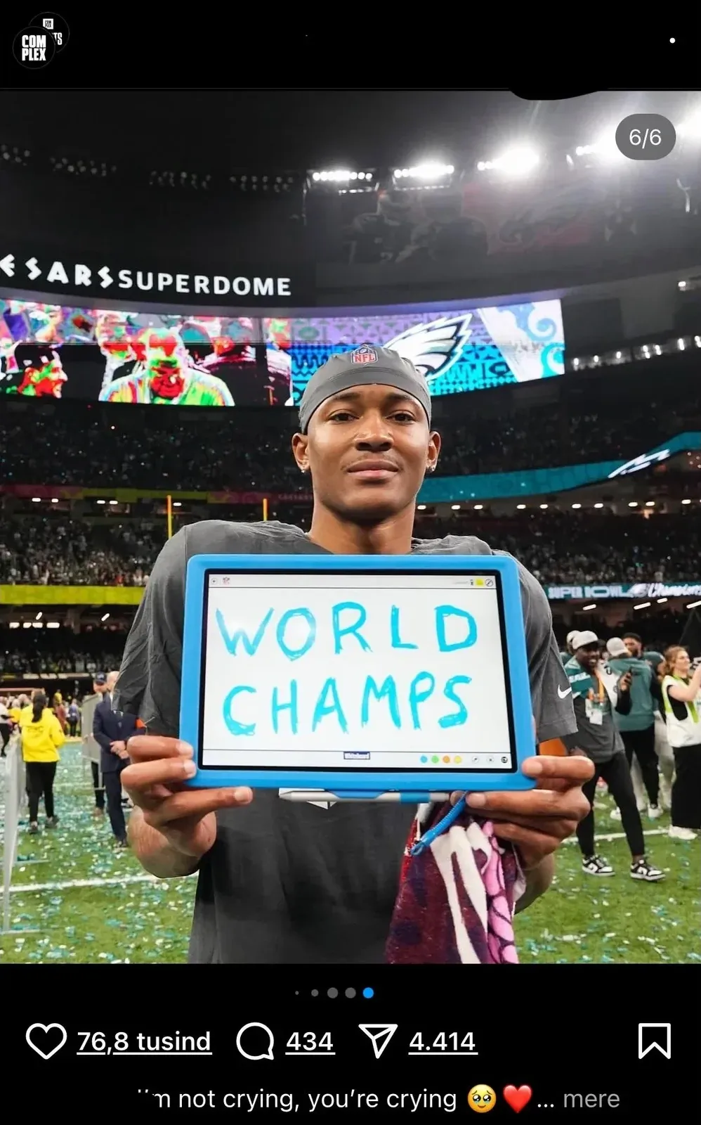 Instagram/social media post showing an NFL player in Philadelphia Eagles jersey on the field at Caesars Superdome, holding up a small whiteboard with "WORLD CHAMPS" handwritten on it. Fox Sports watermark, image 6/6. 76.8 tusind (Danish) likes