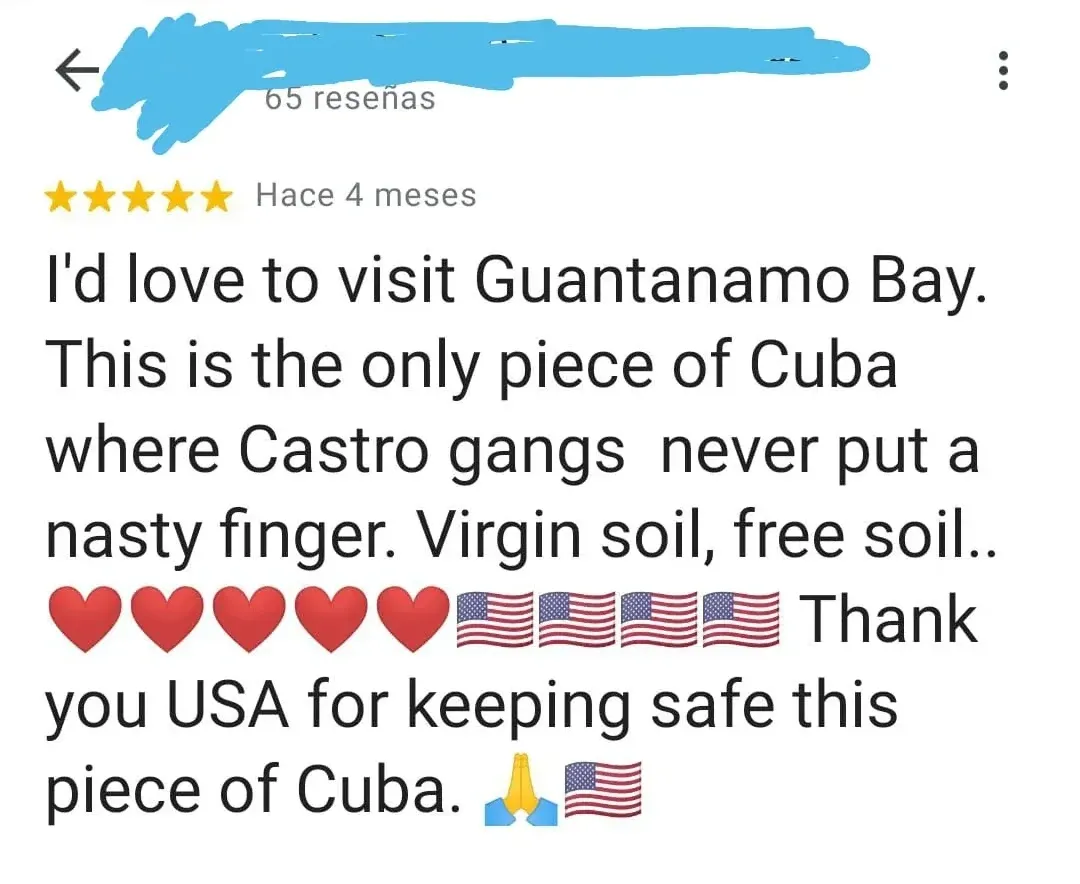 Google Maps review screenshot (Spanish interface - "65 resenas", "Hace 4 meses"). 5-star review (username redacted): "I'd love to visit Guantanamo Bay. This is the only piece of Cuba where Castro gangs never put a nasty finger. Virgin soil, free soil.." followed by red heart emojis and American flag emojis, "Thank you USA for keeping safe this piece of Cuba." with prayer hands and US flag emoji