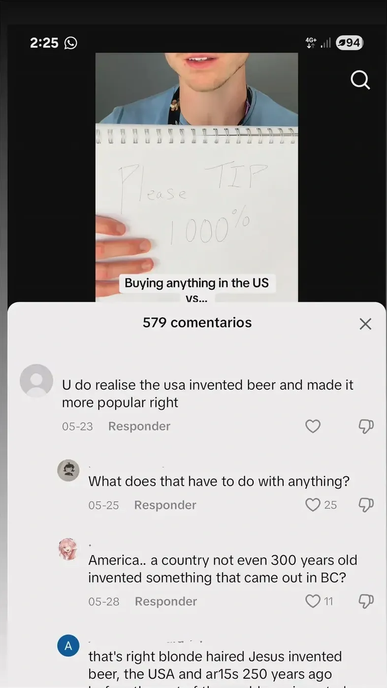TikTok comment section (Spanish interface). Video shows person holding notepad reading Please TIP 1000% with caption Buying anything in the US vs... Comment: U do realise the usa invented beer and made it more popular right. Reply: What does that have to do with anything? Reply: America.. a country not even 300 years old invented something that came out in BC?