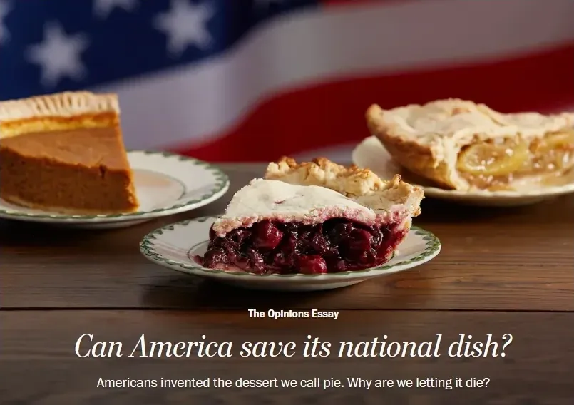 News article screenshot. The Opinions Essay header. Headline: Can America save its national dish? Subhead: Americans invented the dessert we call pie. Why are we letting it die? Photo shows three pies (cherry, pumpkin, apple) on a wooden table with blurred American flag background