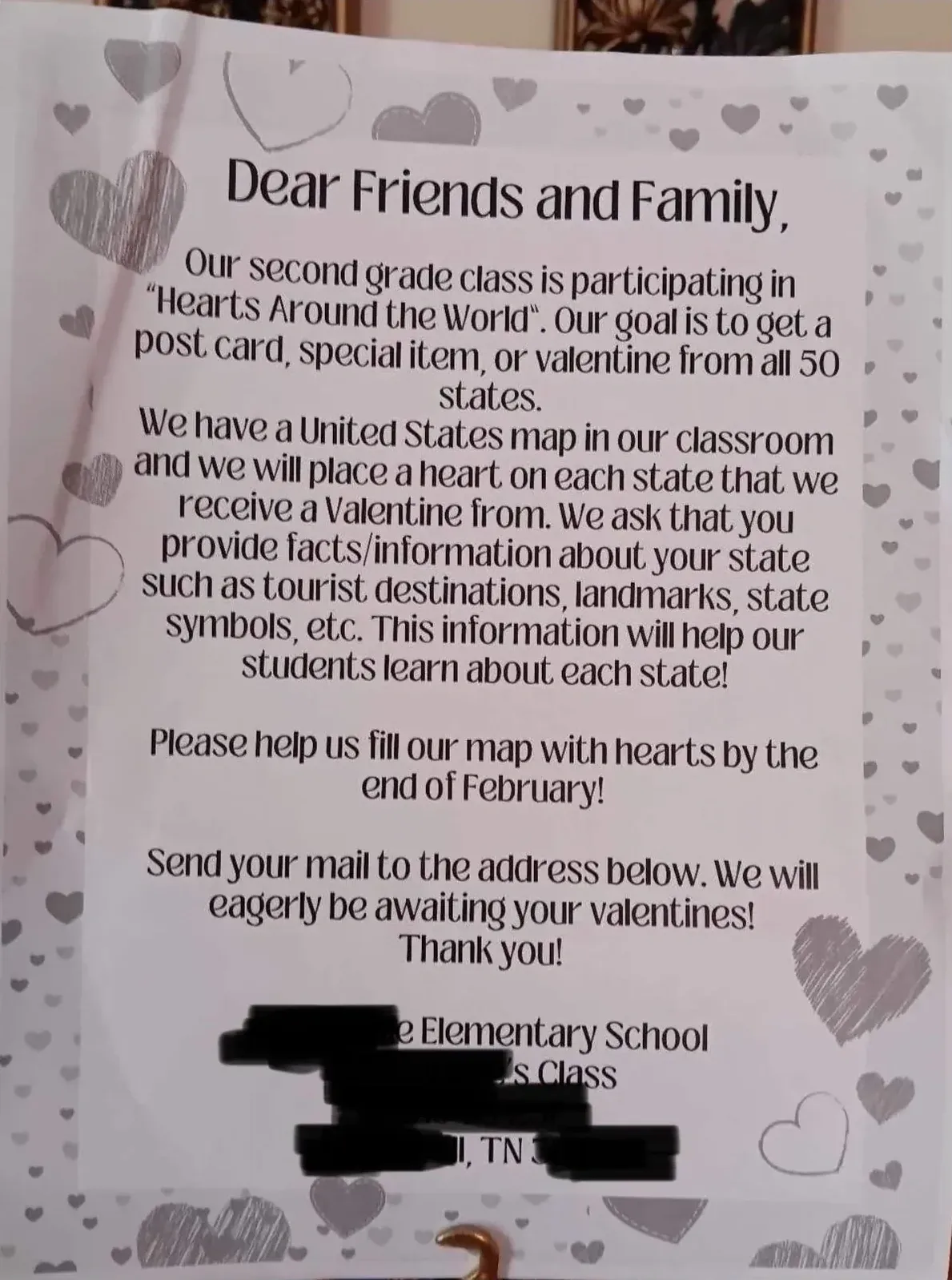 Photo of a printed letter with heart decorations around the border. "Dear Friends and Family, Our second grade class is participating in 'Hearts Around the World'. Our goal is to get a post card, special item, or valentine from all 50 states." Asks recipients to provide facts about their state - tourist destinations, landmarks, state symbols. Address partially redacted - Elementary School, TN
