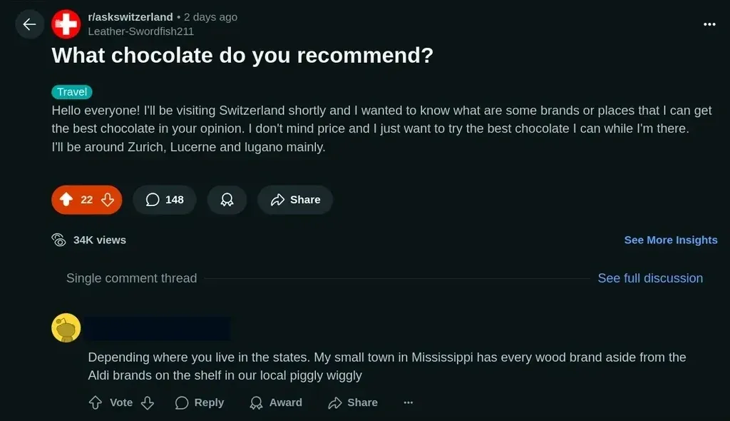 Reddit post on r/askswitzerland by Leather-Swordfish211 titled "What chocolate do you recommend?" asking about the best chocolate in Switzerland. Tagged Travel. A reply reads "Depending where you live in the states. My small town in Mississippi has every wood brand aside from the Aldi brands on the shelf in our local piggly wiggly"