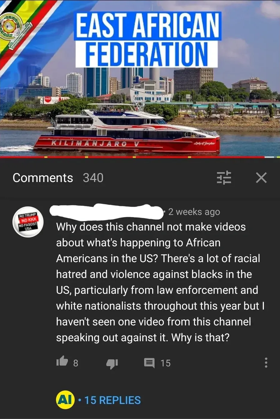 YouTube video screenshot showing "EAST AFRICAN FEDERATION" title with a striped flag, and a red catamaran ferry with "KILIMANJARO" written on it in a harbour. A comment (2 weeks ago) reads "Why does this channel not make videos about what's happening to African Americans in the US? There's a lot of racial hatred and violence against blacks in the US, particularly from law enforcement and white nationalists throughout this year but I haven't seen one video from this channel speaking out against it. Why is that?"