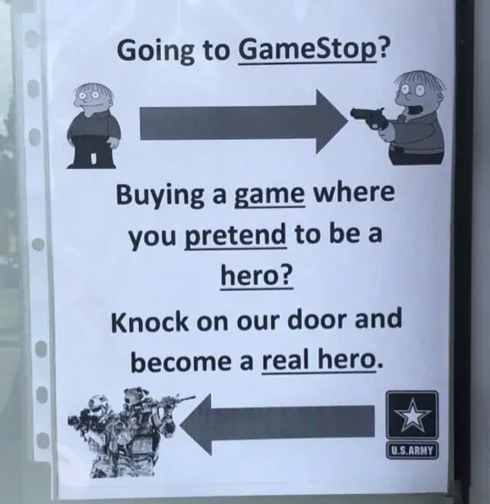 Printed flyer photographed on a door or window. Text: "Going to GameStop?" with cartoon of one character pointing a gun at another. Arrow pointing right. "Buying a game where you pretend to be a hero? Knock on our door and become a real hero." Image of soldiers in combat gear with U.S. Army logo below. A US Army recruitment poster placed near a GameStop store.