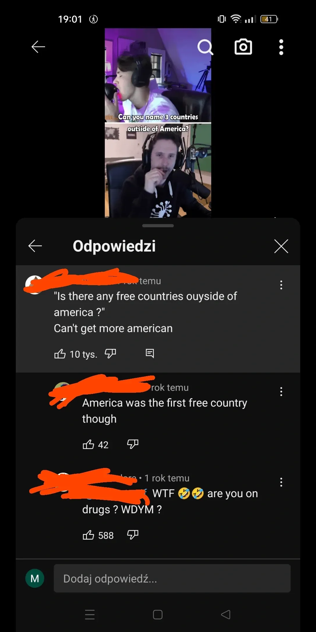 YouTube comments section (Polish interface - Odpowiedzi means Replies, rok temu means year ago). Video still at top shows a streamer/YouTuber wearing headphones at a desk with purple lighting, text overlay: Can you name 3 countries outside of America? Comments below: First (name redacted): Is there any free countries ouyside of america? Can't get more american. Second: America was the first free country though. Third: WTF are you on drugs? WDYM?