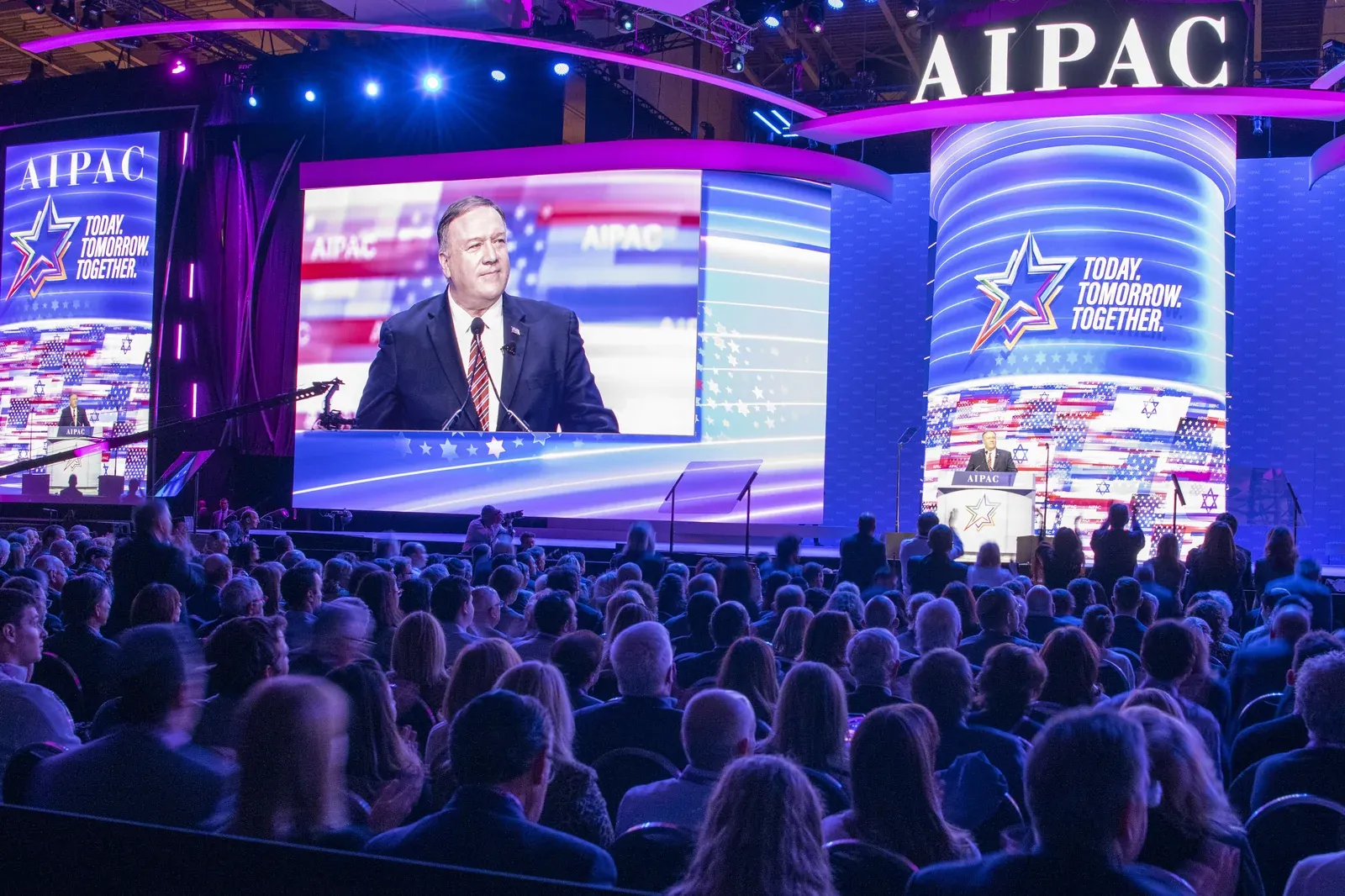 Secretary Pompeo on a huge screen addressing a packed AIPAC conference hall, with 'Today. Tomorrow. Together.' branding