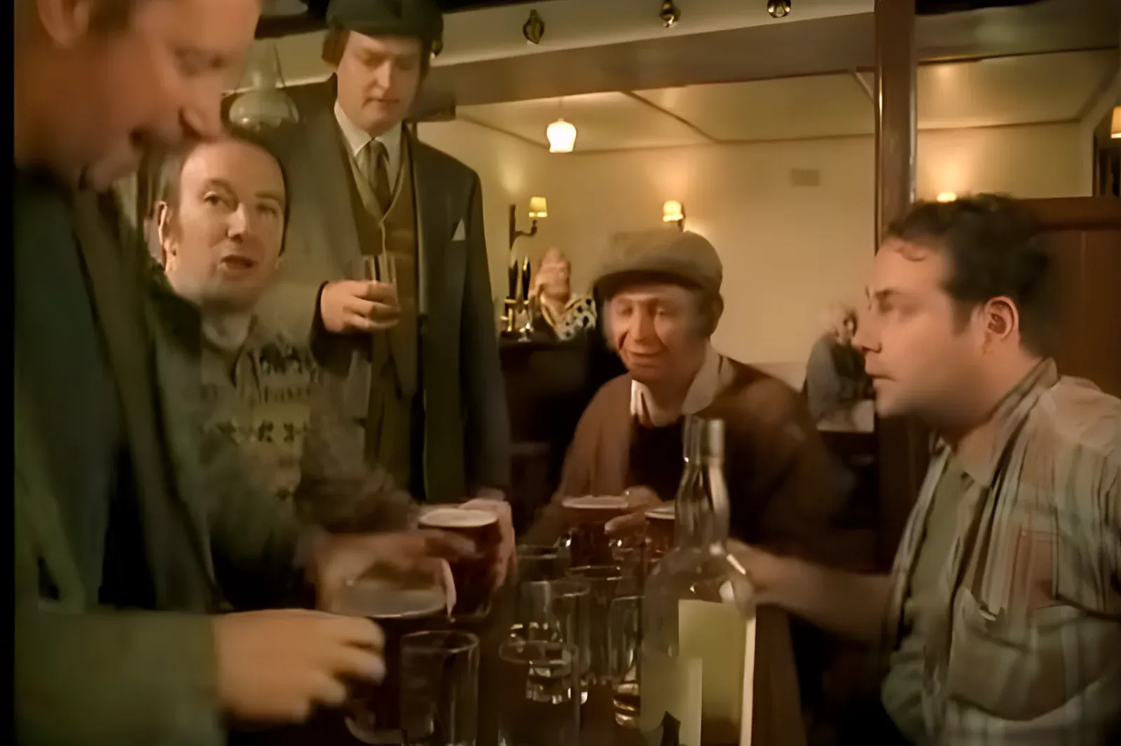 Scene from The Fast Show's Ted and Ralph sketch - men drinking pints in a warmly lit country pub